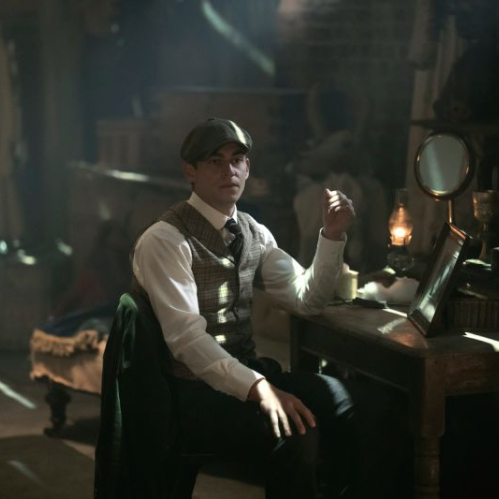 Escena de El Joven Sherlock con el protagonista sentado en una habitación de época con iluminación tenue y ambientación victoriana.