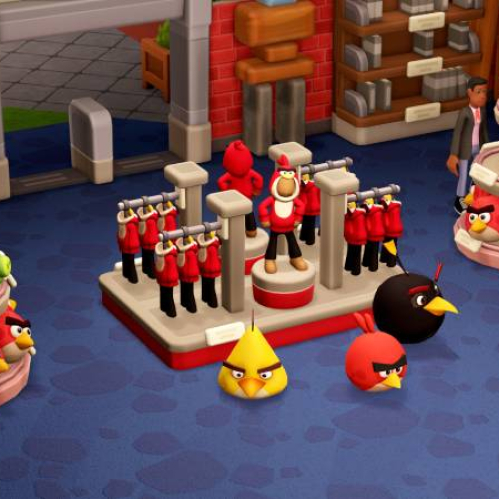 Espacio interior colorido con estanterías repletas de peluches y artículos inspirados en Angry Birds, acompañado por visitantes que recorren la tienda.