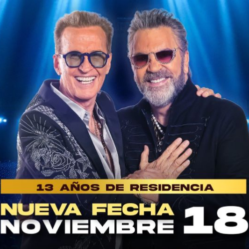 Cartel promocional con Emmanuel y Mijares sonriendo vestidos con trajes oscuros sobre un fondo de luces doradas y azules, anunciado la fecha del 18 de noviembre en el Auditorio Nacional.