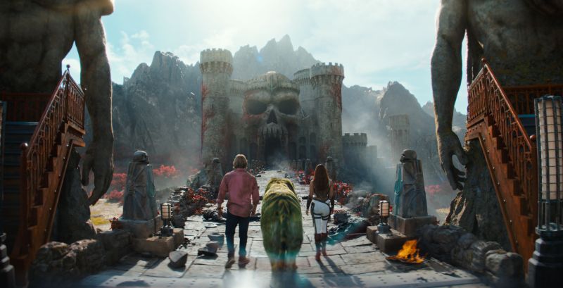 Amos del Universo — Grayskull Grupo caminando hacia castillo con fachada de calavera.