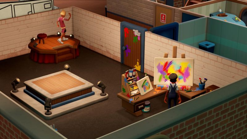 Artista pintando un lienzo colorido dentro de un estudio con materiales de arte.
