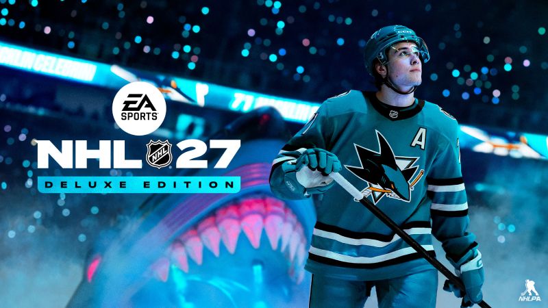 Un jugador de hockey sobre hielo vistiendo el uniforme azul de San Jose Sharks sostiene su palo en la pista, con la cabeza de un tiburón con la boca abierta e iluminación azul de fondo junto al logotipo de EA SPORTS NHL 27 Deluxe Edition.